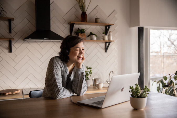 Woman at table with laptop learning French