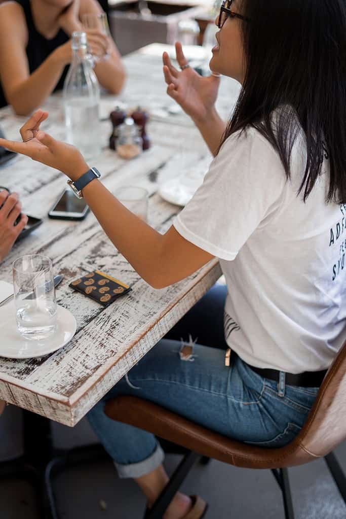 A young Asian lady chatting at a French conversation class near you.